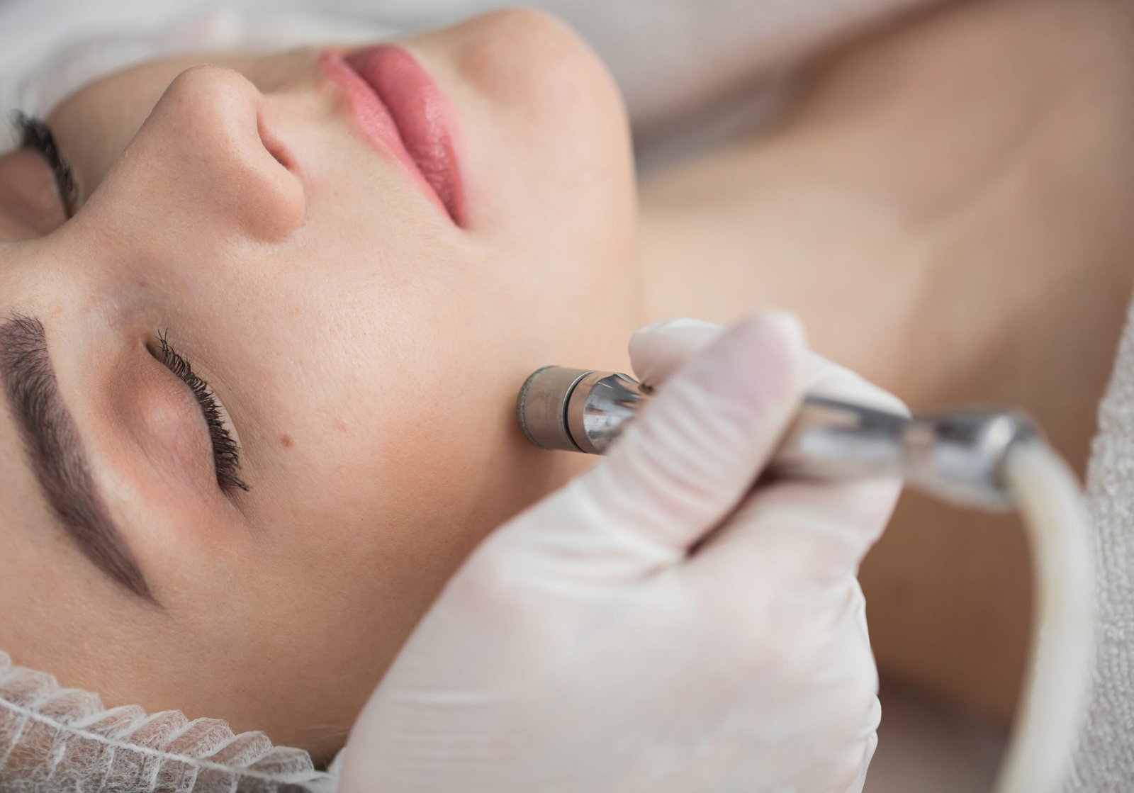 Diamond microdermabrasion, peeling cosmetic. woman during a microdermabrasion treatment in beauty salon Diamond microdermabrasion, peeling cosmetic. woman during a microdermabrasion treatment in beauty salon