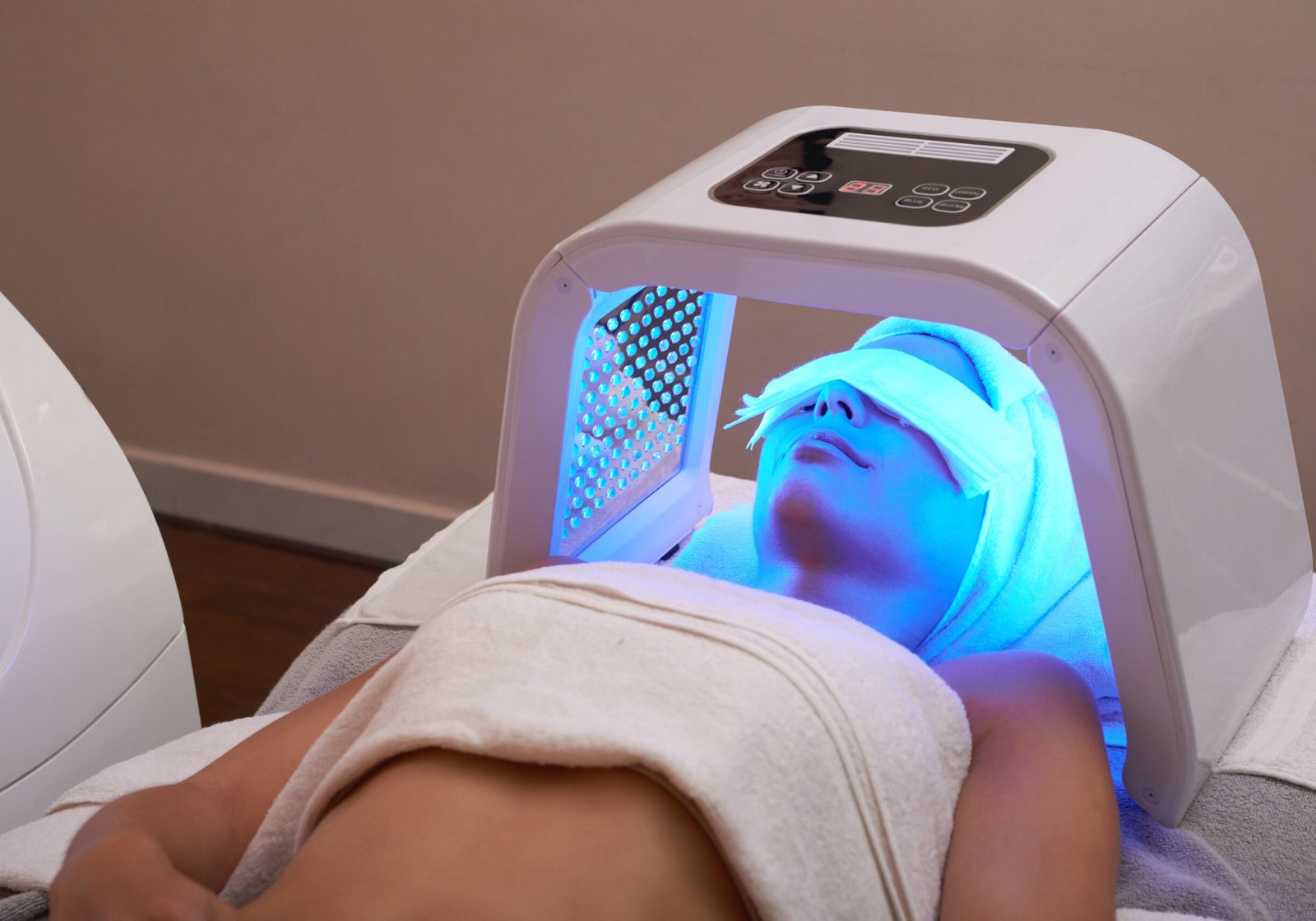 LED light facial Young woman having LED light facial treatment in beauty salon